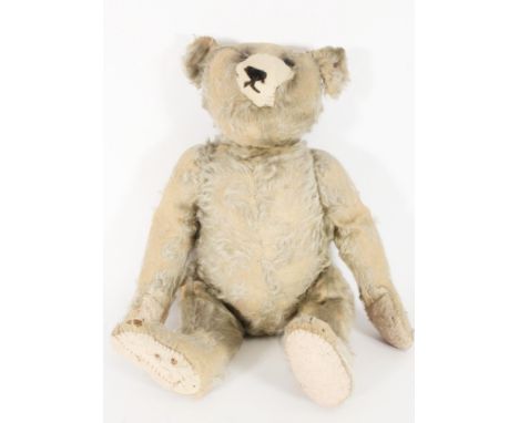 Steiff, a vintage straw filled mohair teddy bear with articulated arms and legs and hunched back, metal button in ear, 48cm t