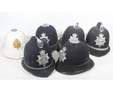 White tropical helmet with Royal Marines Gibraltar Per Mare Per Terram gilt metal helmet plate badge, and five police helmets
