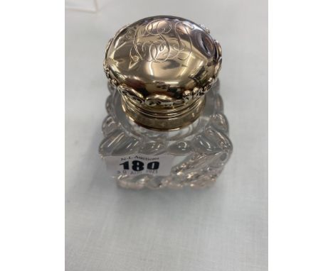 An inkwell with hallmarked Silver lid a.f
