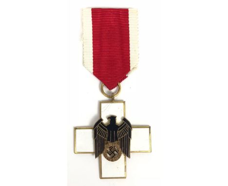 German Third Reich Social Welfare Decoration 3rd Class.  Good scarce uniface breast badge. White enamel cross with applied bl