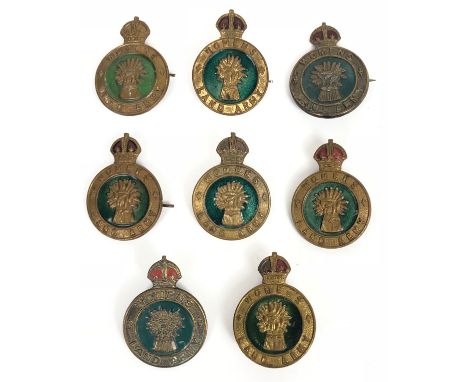 8 WW2 Home Front Women's Land Army Hat Badges.  Eight original examples with enamel decoration All complete with fittings (7x