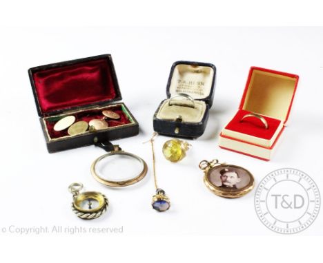 Two 9ct yellow gold cufflinks (not matching) weight 7.4gms gross, a compass charm, two fobs, two photo lockets and two weddin