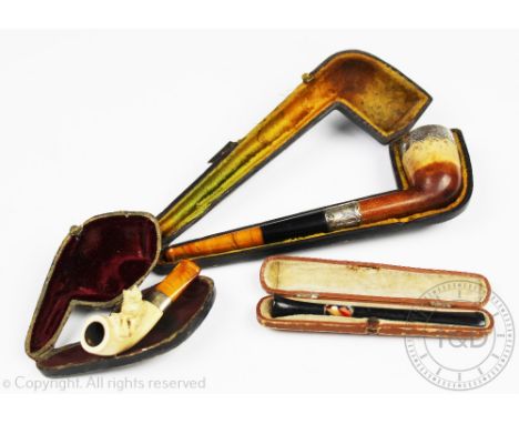 A Victorian silver mounted pipe, W H Newman Ltd, Birmingham 1898, a carved meerschaum pipe with amber coloured mouth piece, 7