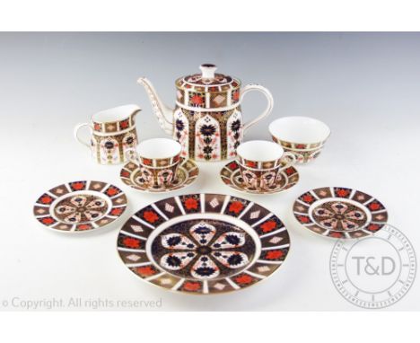 A Royal Crown Derby Old Imari 1128 pattern part tea service comprising; a teapot and cover, two cups and saucers, two cake pl