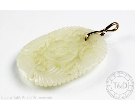 A carved jade pendant, the lozenge shaped panel carved with moths, flowers and foliage, with later pendant fitting stamped '9