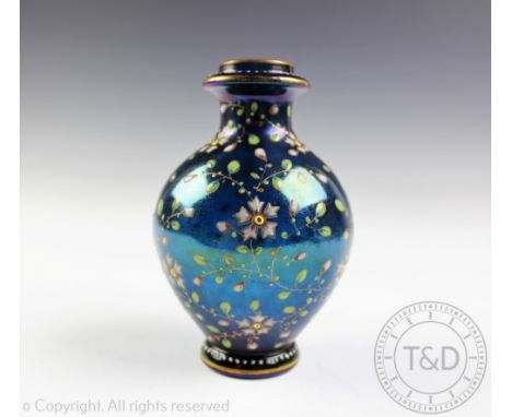 A late 19th century Bohemian glass vase in the manner of Moser, painted externally with floral sprays against a iridescent tu