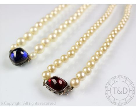 Two imitation pearl necklaces with large cabochon set clasps, comprising a cushion shaped blue and a rectangular red cabochon