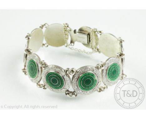 An enamelled bracelet stamped 'Silver', designed as ten circular links, each with green enamelled concentric circle design, i