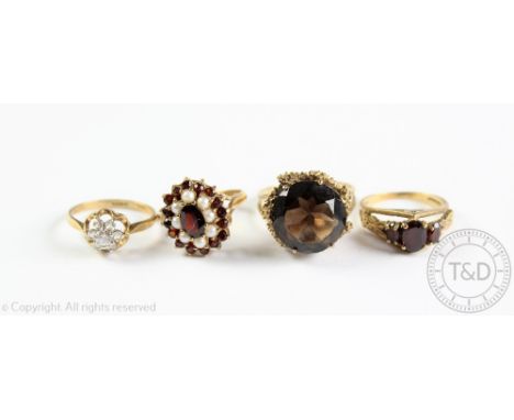 Four assorted rings, comprising; a garnet and pearl oval cluster ring in 9ct gold, a garnet set 9ct gold ring, a smokey quart