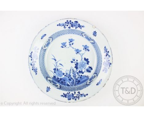 An 18th century Chinese porcelain blue and white basin, internally decorated centrally with chrysanthemum and peony blooms wi