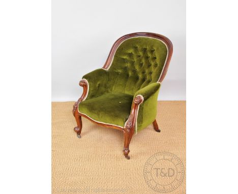 A Victorian carved mahogany salon chair, with button back green upholstery, on cabriole legs, 95cm H