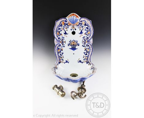 A French faience wall fountain, of 18th century style with shell shaped bowl and reeded silver plated double tap, 46cm high