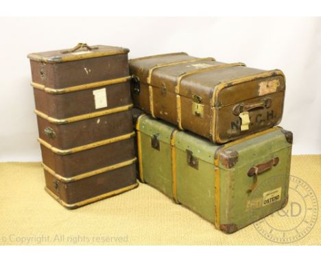 A large early 20th century green canvas and wooden bound steamer trunk, with two handles and travelling labels, 51cm H x 89cm
