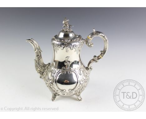 A Victorian silver coffee pot, Goldsmiths Alliance London 1886, the finial modelled as a bird, with all over cast and repouss