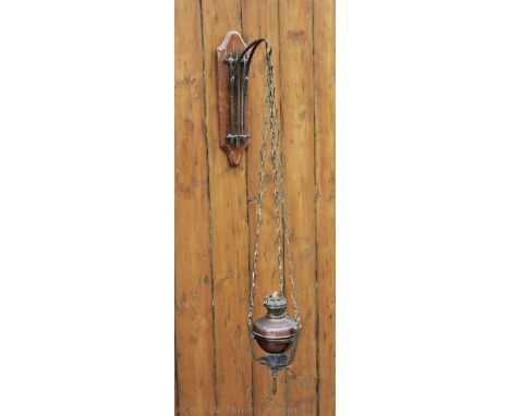 An Arts and Crafts brass and copper wall mounted hanging oil lamp, 85cm H