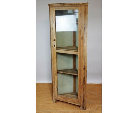 An Edwardian pine corner cabinet, with one long door enclosing shelves, on bracket feet, 186cm H x 71cm W