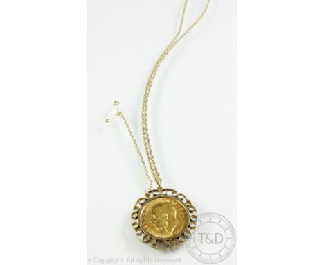 A George V gold sovereign dated 1913, within 9ct yellow gold pendant surround and attached chain with bolt ring clasp stamped