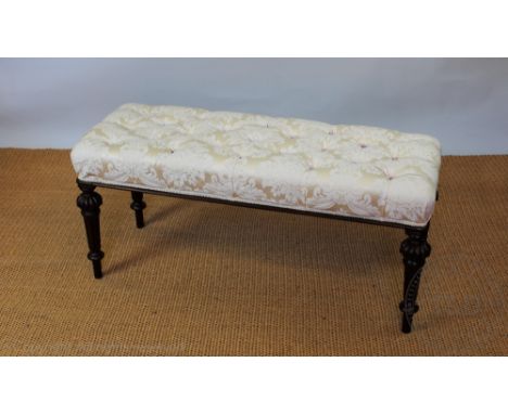 A late Victorian walnut duet stool, the top with floral button upholstery, on turned and fluted legs, 48cm H x 104cm W x 39cm