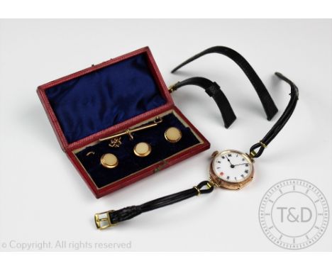 A lady's 9ct gold wristwatch, case stamped '282154', Roman numeral dial against a white face with gilt jeweled minutes, attac