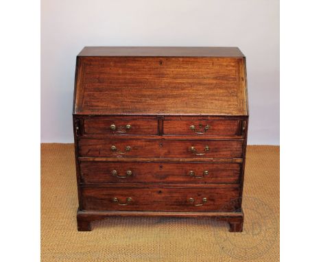 A George III mahogany bureau, with fall enclosing a fitted interior, over two short and three graduated long drawers, on brac
