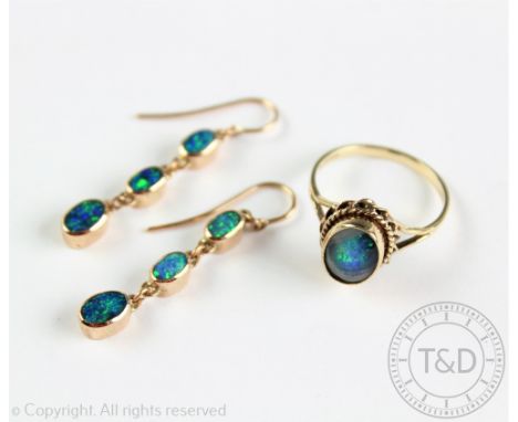 A pair of 'black opal' set drop earrings, each set with a drop of three graduated, untested opals, collet set and with hoop f