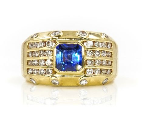 A YELLOW GOLD, SAPPHIRE AND DIAMOND RINGMounted with the cut cornered rectangular emerald cut sapphire at the centre and othe