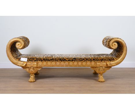 AN EGYPTIAN REVIVAL GILT FRAMED LEOPARD PRINT UPHOLSTERED SCROLL END SOFAWith sea serpent mounts and paw feet, 220cm wide; 66