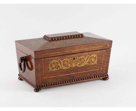 A REGENCY BRASS INLAID ROSEWOOD SARCOPHAGUS TEA CADDYWith twin lidded interior centred by a mixing bowl, 38cm wide; 18cm deep