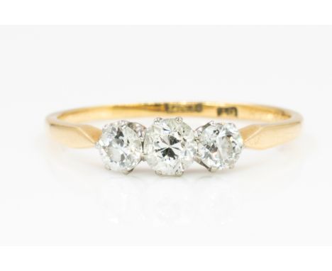 A GOLD AND DIAMOND THREE STONE RINGClaw set with a row of cushion shaped diamonds, detailed 18, ring size P and a half, gross