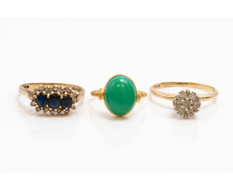 THREE GOLD AND GEM SET RINGS (3)Comprising; a 9ct gold ring, claw set with three oval cut sapphires within a surround of circ