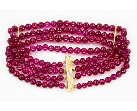 A TREATED RUBY BEAD BRACELET AND THREE SINGLE ROW NECKLACES (4)The four row ruby bead bracelet on a sliding clasp, unmarked, 