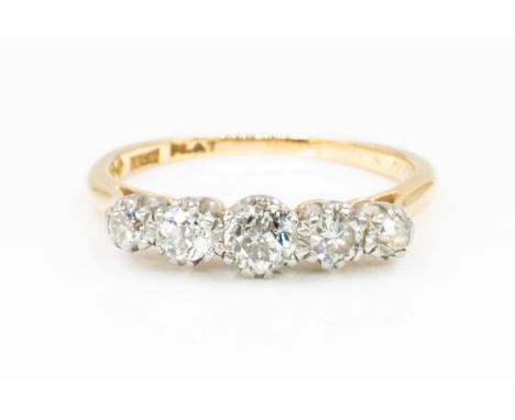 A GOLD AND DIAMOND FIVE STONE RINGClaw set with a row of cushion shaped diamonds, graduating in size to the centre stone, det