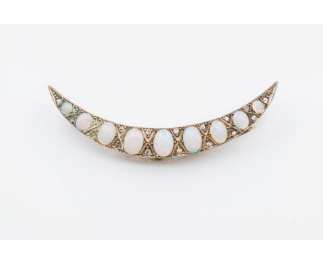 A VICTORIAN OPAL AND DIAMOND CRESCENT BROOCHSet with nine oval opals each separated by diamond chips, mounted in gold and wit