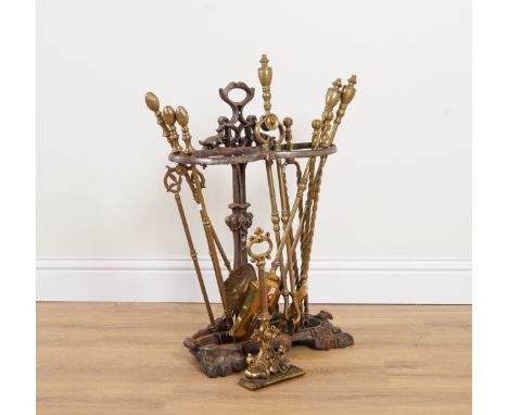 A VICTORIAN BRASS LEAD WEIGHTED DOOR STOP; TOGETHER WITH A CAST-IRON STICK STAND AND THREE SETS OF BRASS FIRE-TOOLS (11)19th 