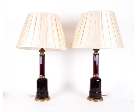 A PAIR OF RUBY COLOURED GLASS OCTAGONAL COLUMN TABLE LAMPS (2)Modern With gilt-metal mounted stepped octagonal bases, 53cm hi