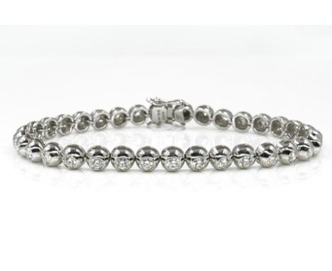 A WHITE GOLD AND DIAMOND TENNIS BRACELETThe circular links mounted with circular cut diamonds, on a snap clasp, with foldover