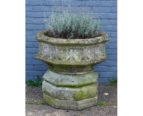 A GOTHIC REVIVAL RECONSTITUTED STONE OCTAGONAL FONT BASINWith quatrefoil frieze and waisted base with foliate carved motifs, 