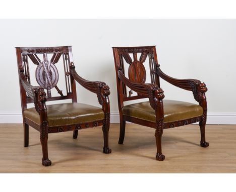 A PAIR OF LARGE CARVED HARDWOOD FRAMED OPEN ARMCHAIRS (2)With arrow and shield back and beast head arm finials, 75cm wide; 10