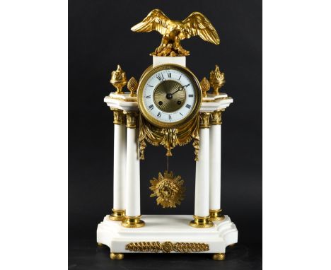 A FRENCH LOUIS XVI STYLE GILT-METAL MOUNTED WHITE MARBLE PORTICO MANTEL CLOCKThe case surmounted by an eagle, the engine-mill