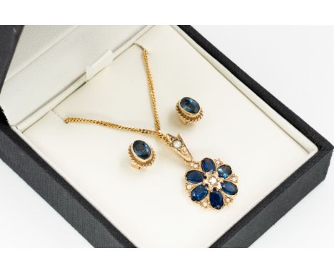 A SAPPHIRE AND DIAMOND PENDANT WITH A PAIR OF SAPPHIRE SINGLE STONE EARSTUDS (2)Comprising; a 9ct gold pendant, mounted with 