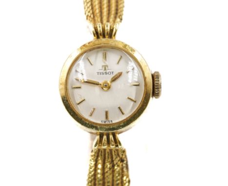 A TISSOT GOLD CIRCULAR CASED LADY'S WRISTWATCHWith a signed jewelled movement, a signed silvered dial with baton hour markers