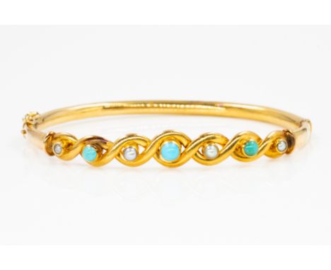 A GOLD, TURQUOISE AND HALF PEARL OVAL HINGED BANGLEThe front in a serpentine design, mounted with alternating half pearls and