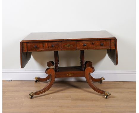 A REGENCY BRASS INLAID ROSEWOOD TWO DRAWER SOFA TABLEOn downswept supports, 105cm wide; 166cm wide open; 68cm deepCondition; 