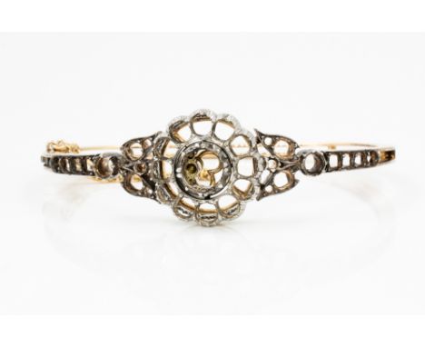 A GOLD AND SILVER OVAL HINGED BANGLE MOUNTProbably circa 1900 (the central cluster detachable) the gemstones lacking, weight 