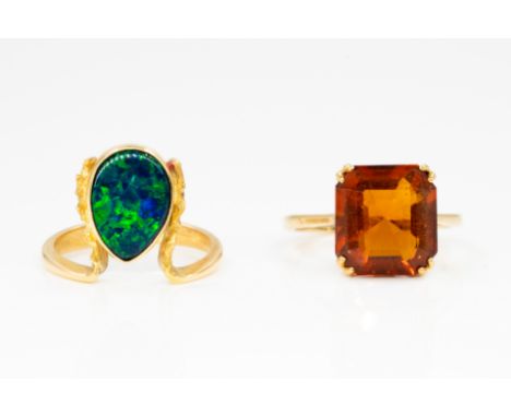 A GOLD AND BLACK OPAL DOUBLET RING AND A GOLD AND CITRINE SINGLE STONE RING (2)The first ring collet set with a pear shaped b