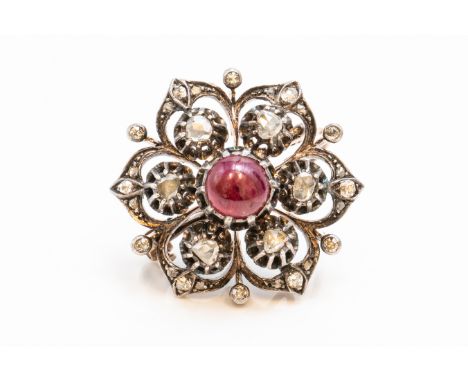 A DIAMOND AND CABOCHON RUBY HEXAGONAL BROOCHIn a pierced hexagonal design, mounted with the cabochon ruby at the centre, in a