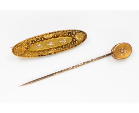 A 15CT GOLD AND DIAMOND BROOCH AND A GOLD AND DIAMOND TOPPED STICK PIN (2)The oval brooch star gypsy set with three cushion s