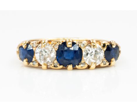 A GOLD, SAPPHIRE AND DIAMOND FIVE STONE RINGMounted with three cushion shaped sapphires, alternating with two cushion shaped 