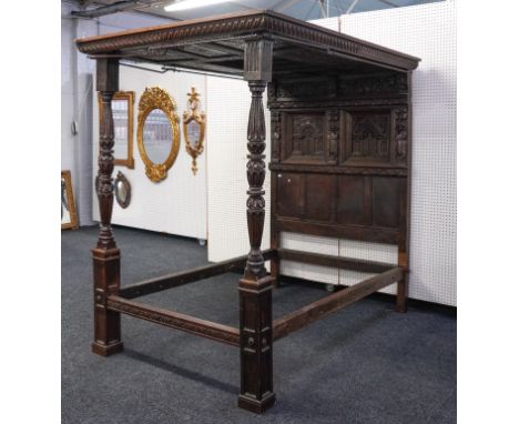 AN OAK FOUR POSTER BED WITH CARVED AND PANELLED CONOPY AND HEADBOARDElements 17th century and later, 160cm wide; 220cm long; 