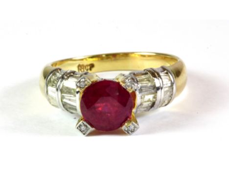 An 18ct yellow gold ring set with a brilliant cut ruby and diamond set shoulders and shank, (ruby is chipped on the pavilion)
